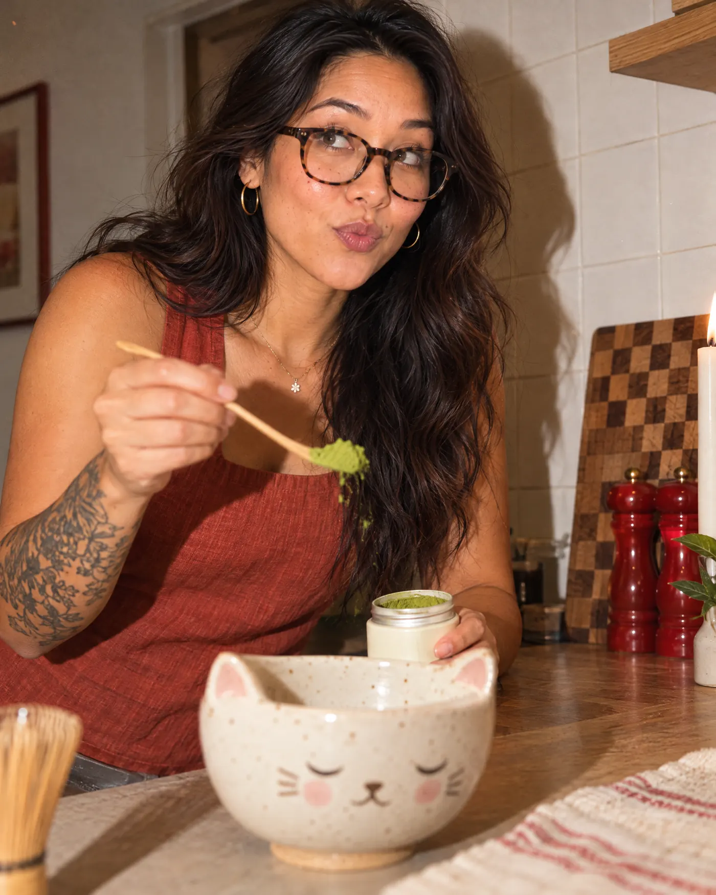 A woman scooping matcha powder at her kitchen counter